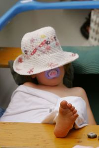 Girl sleeping with feet up on table at home