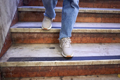 Low section of man standing on staircase