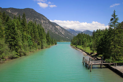 Scenic view of lake and mountains against sky