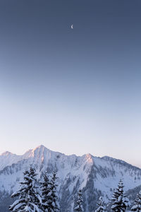 Scenic view of snowcapped mountains against clear sky