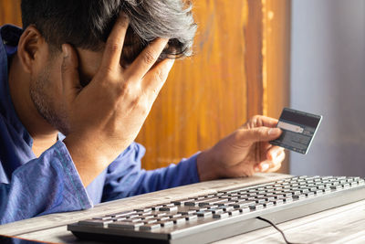 Close-up of man using laptop