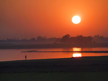 Scenic view of sunset over lake