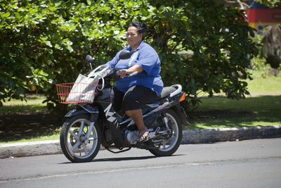 Portrait of man riding bicycle on road in city