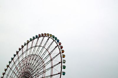 Low angle view of ferris wheel against clear sky