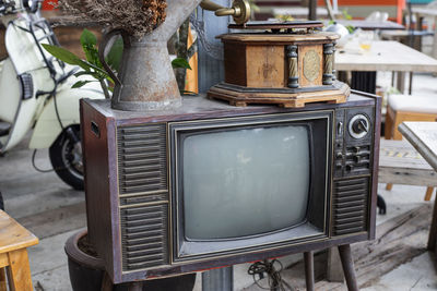 Close-up of old gramophone with vase on television set