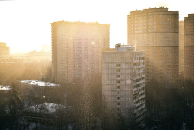 Buildings against sky in city during winter