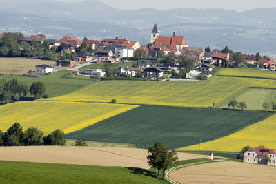 High angle view of houses and buildings on field