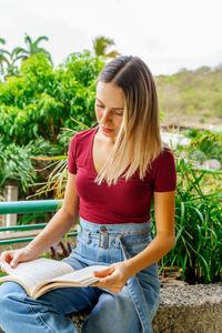 Young woman sitting on bench