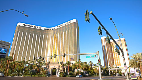 Low angle view of buildings against clear blue sky