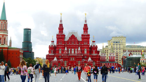 Group of people walking in front of buildings