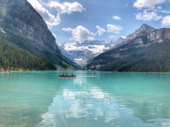 Scenic view of lake and mountains against sky