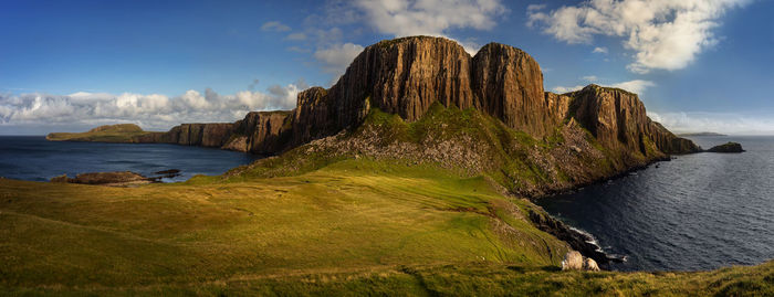 Panoramic view of rocks on beach against sky