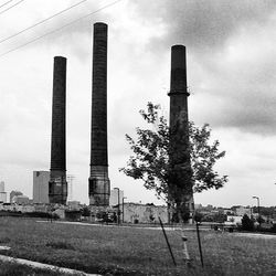 Factory against cloudy sky