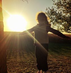 People standing on field during sunny day