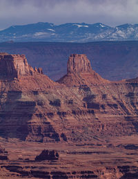 Rugged red sandstone rock formations tower above the eroded landscape