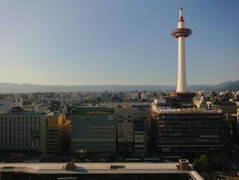 Buildings in city against clear sky