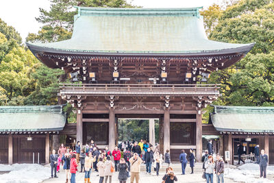 Group of people outside temple against building