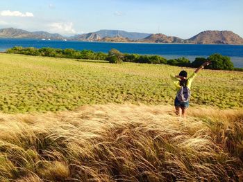 Woman standing on grassy field