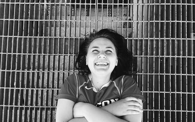 Portrait of smiling young woman sitting outdoors