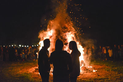 People watching fire at night