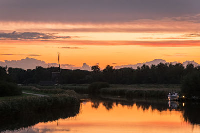 Scenic view of silhouette trees against orange sky