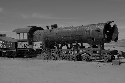 Locomotive on field against sky