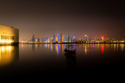 Illuminated skyline of doha, qatar with illuminated museum of islamic art at night