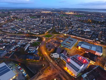 High angle view of illuminated street amidst buildings in city