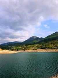 Scenic view of lake and mountains against sky