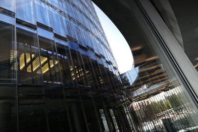 Low angle view of modern glass building in city