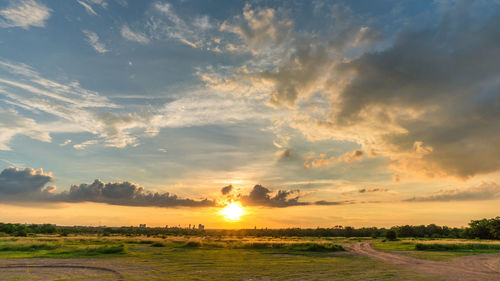 Scenic view of field against sky during sunset