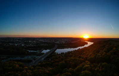 High angle view of river amidst landscape against sky during sunset