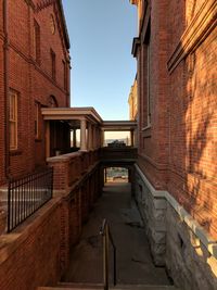 Alley amidst buildings against sky