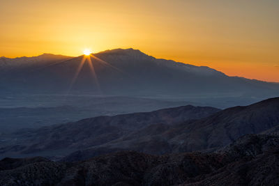 Scenic view of mountains against sky during sunset