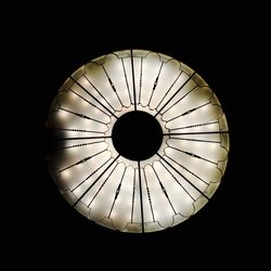 Close-up of illuminated lamp against black background