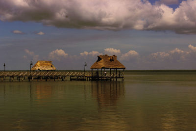 Built structure by sea against sky