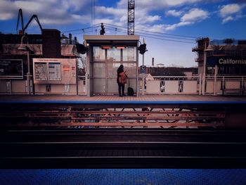 Railroad track against cloudy sky