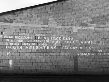 Text on brick wall