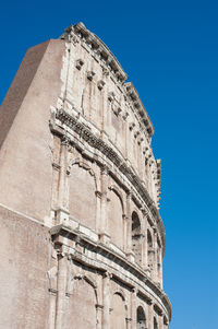 Low angle view of built structure against clear blue sky