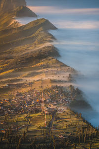 Aerial view of land and sea against sky