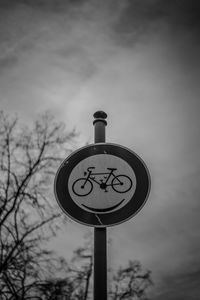 Low angle view of road sign against sky