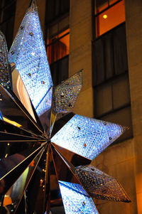 Low angle view of illuminated christmas lights at night