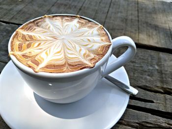 Close-up of cappuccino served on table