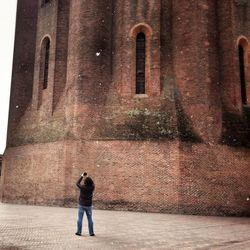 Woman standing in front of historic building