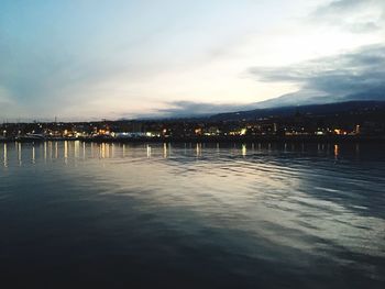 Scenic view of river against sky in city