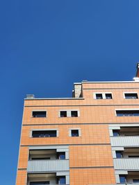 Low angle view of building against clear blue sky