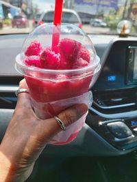 Close-up of hand holding ice cream in glass