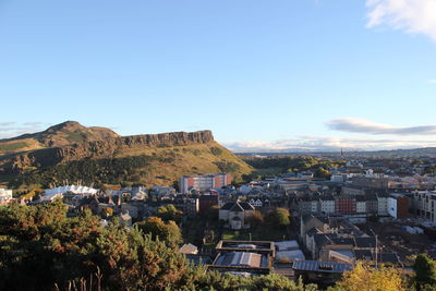 High angle view of city against blue sky