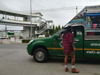 Full length of man standing on road in city
