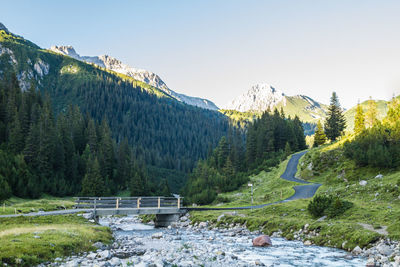 Scenic view of river with mountains in background